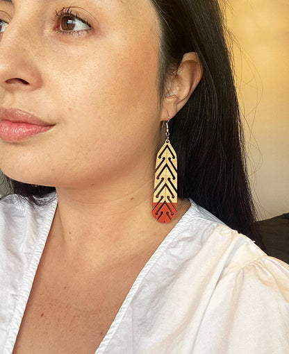Woman wearing huia earring by Mako Design