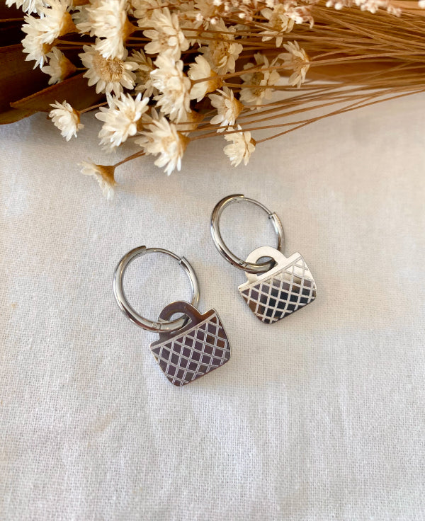 Silver hoop earrings with Maori kete design