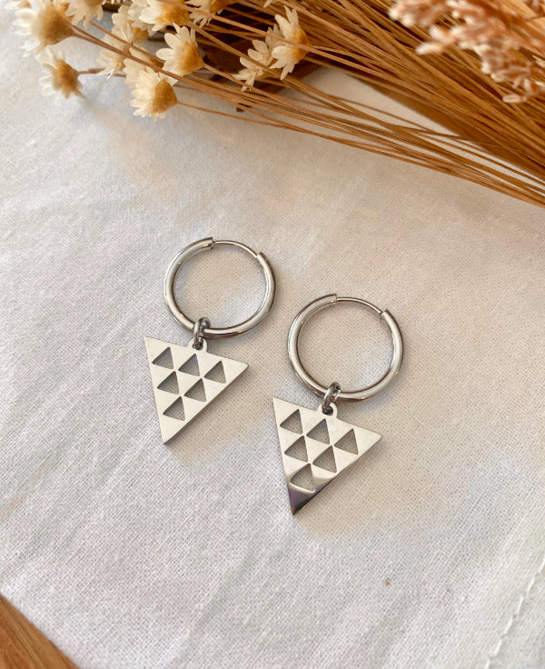 Silver hoop earrings with Maori niho taniwha design