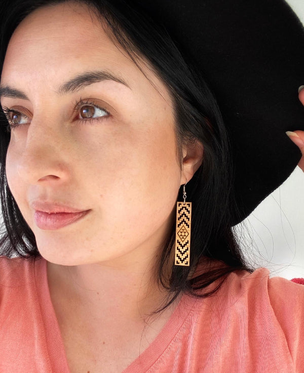 Woman wearing Maori Taniko Poutama earrings