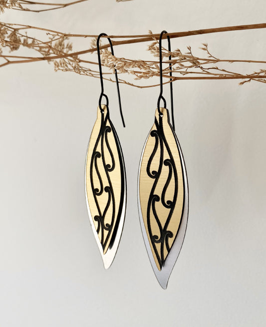 Maori feather earring design in gold and silver